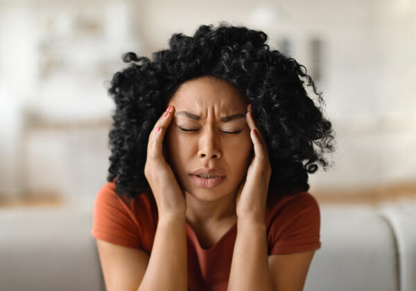 Migraine Concept. Closeup Shot Of Stressed Black Woman Touching